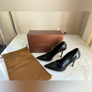 Gucci black leather heels with bamboo accent on heel.